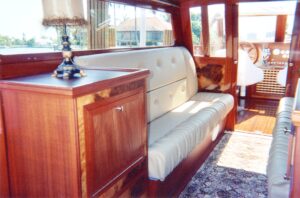 Cozy seating area inside a wooden cabin with a cushioned bench and window views.